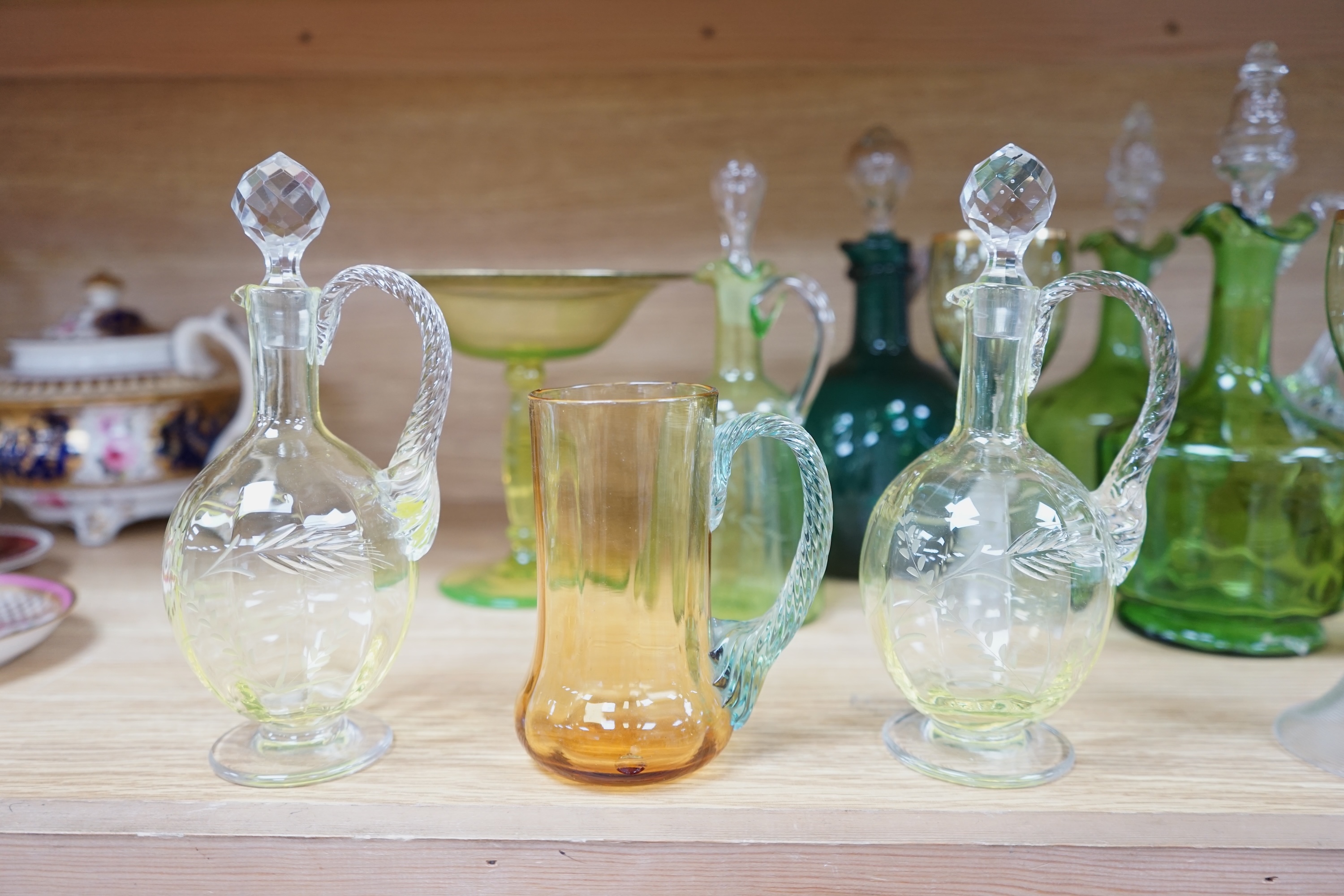 Ten glass items; a pair of green hock glasses, six liqueur decanters, a pedestal table centre and a mug. Condition - good.